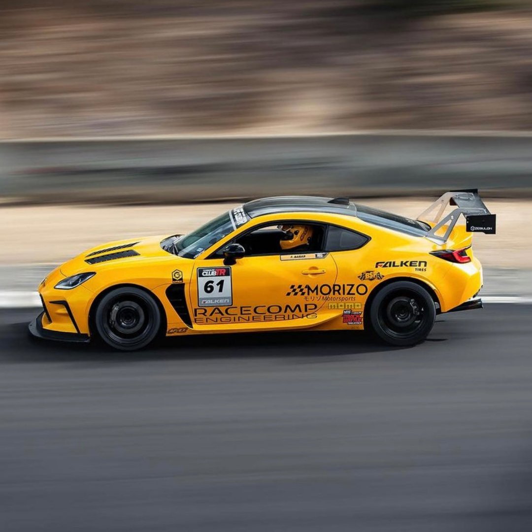 Vibrant Metallic Yellow Vinyl Wrap on Side View of Toyota GR86 on Race Track